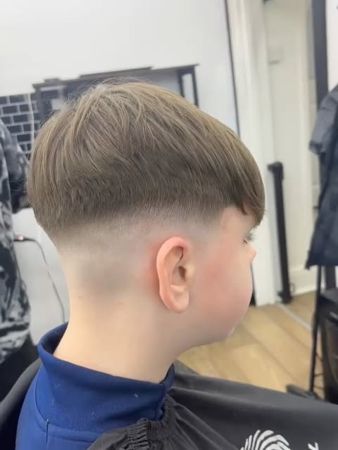 A neat children's haircut with a carefully blended fade